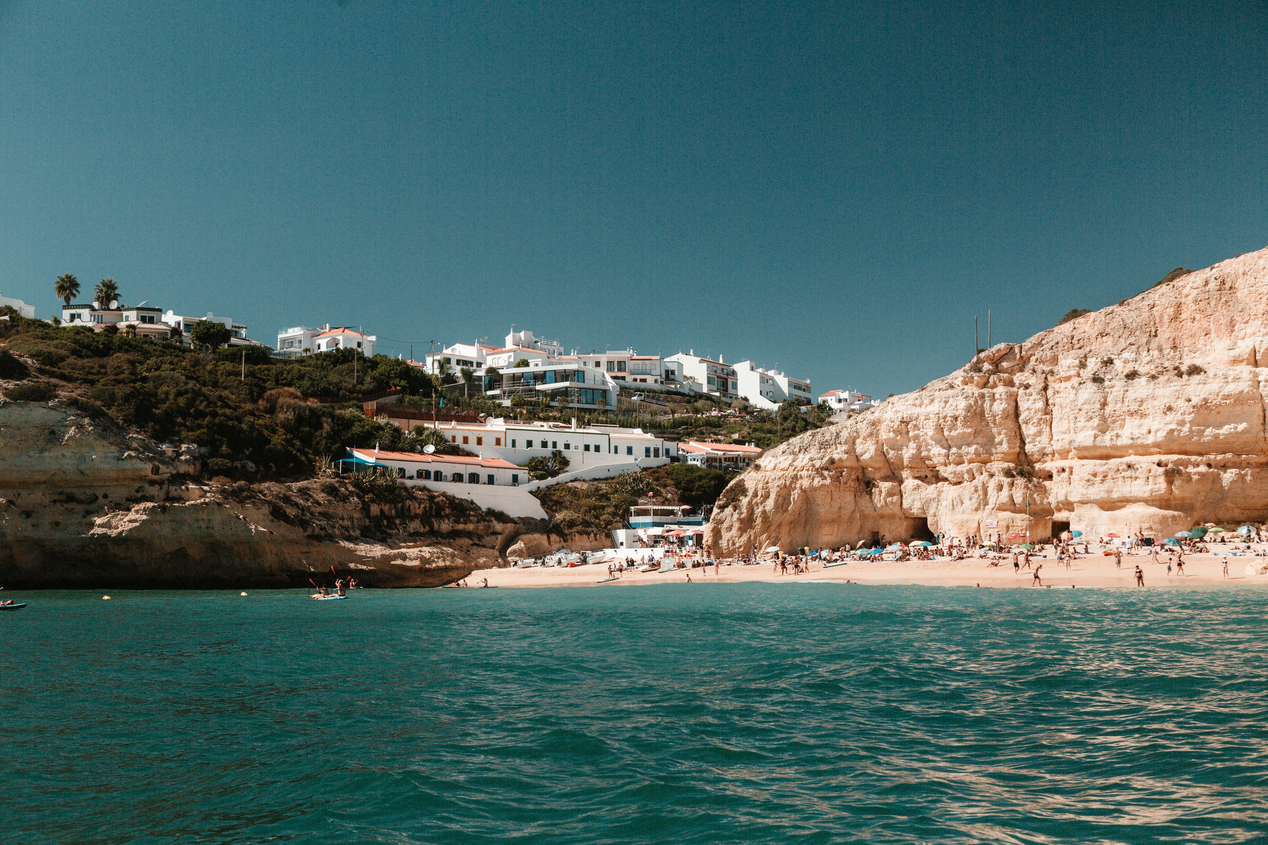 limestone-hills-peppered-with-houses-overlook-a-sandy-beach